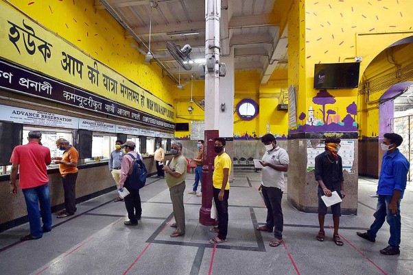 लॉकडाउन के चौथे चरण के दौरान कोलकाता में टिकट आरक्षण काउंटर खुलने के बाद हावड़ा रेलवे स्टेशन पर अपनी टिकट बुक कराने के लिए लाइन में लगे लोग