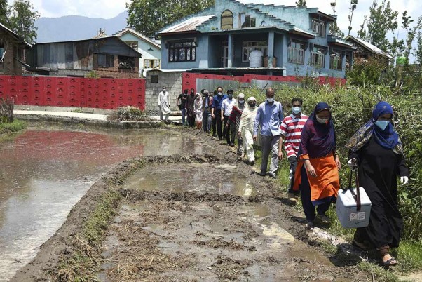 दक्षिण कश्मीर के पुलवामा जिले के त्राल इलाके में घर-घर जाकर कोविड-19 टीकाकरण अभियान चला रहे स्वास्थ्य कार्यकर्ता
