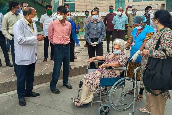 कोरोना वायरस के प्रसार पर अंकुश लगाने के लिए लॉकडाउन के दौरान ग्रेटर नोएडा में अस्पताल से छुट्टी मिलने के बाद घर जाती कोविड-19 की एक मरीज