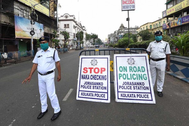 कोरोना वायरस के प्रसार को रोकने के लिए सप्ताहांत पर लॉकडाउन के दौरान सड़कों पर तैनात पुलिसकर्मी