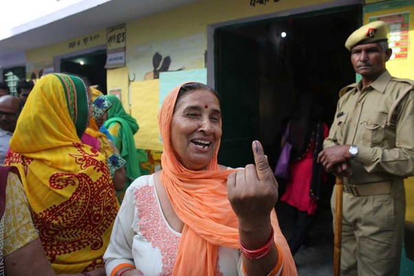 लोकसभा चुनाव के पहले चरण के लिए गाजियाबाद के पास मतदान केंद्र पर अपना वोट डालने के बाद अपनी उंगली पर स्याही का निशान दिखाती महिला
