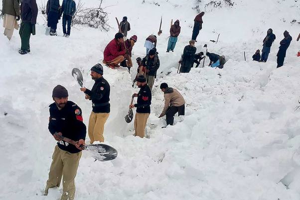 पाकिस्तान अधिकृत कश्मीर के नीलम घाटी के डूडनेल गांव में हिमस्खलन के शिकार लोगों के शवों की खोज करते पुलिस अधिकारी
