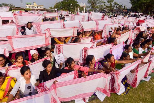 असम के कामरूप जिले के धारापुर में नागरिकता संशोधित कानून के विरोध के दौरान 'गमोसा' (एक तरह का दुपट्टा) लेकर प्रदर्शन करते प्रदर्शनकारी